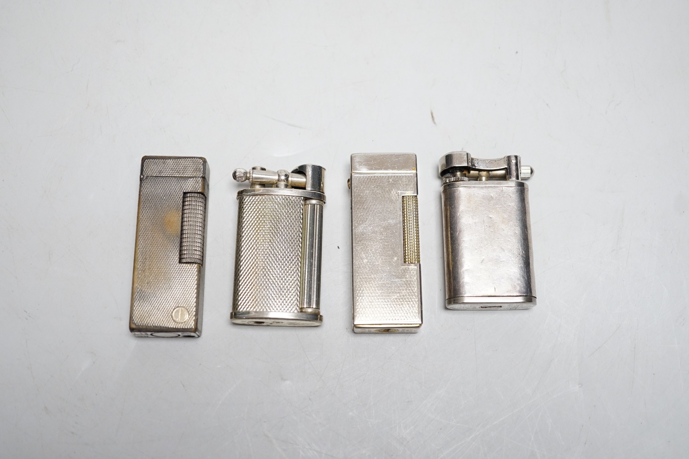 A Dunhill Rollegas lighter and four others
